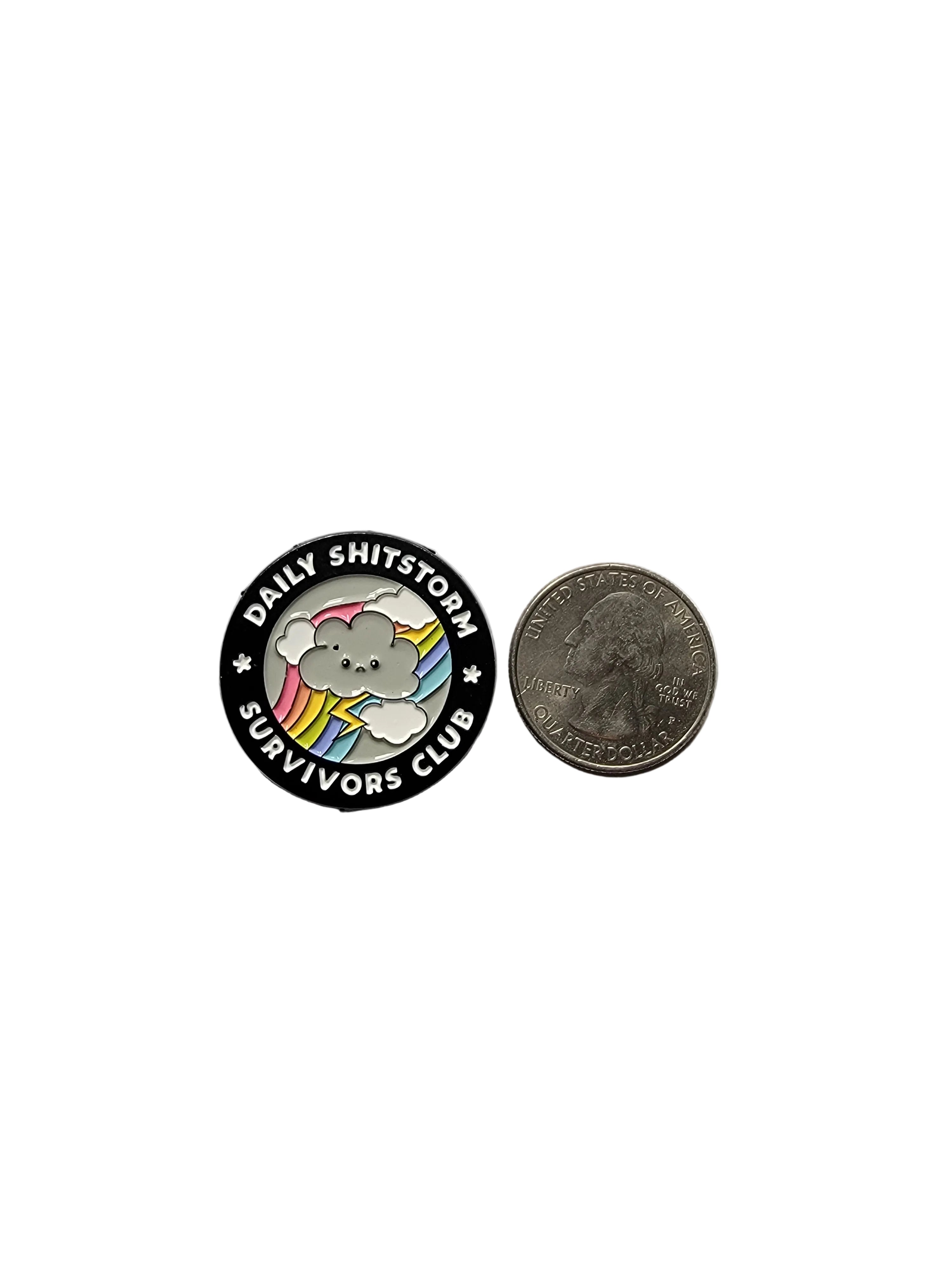 Round button with a cartoon dog design and text, next to a coin for size comparison on a gray background.