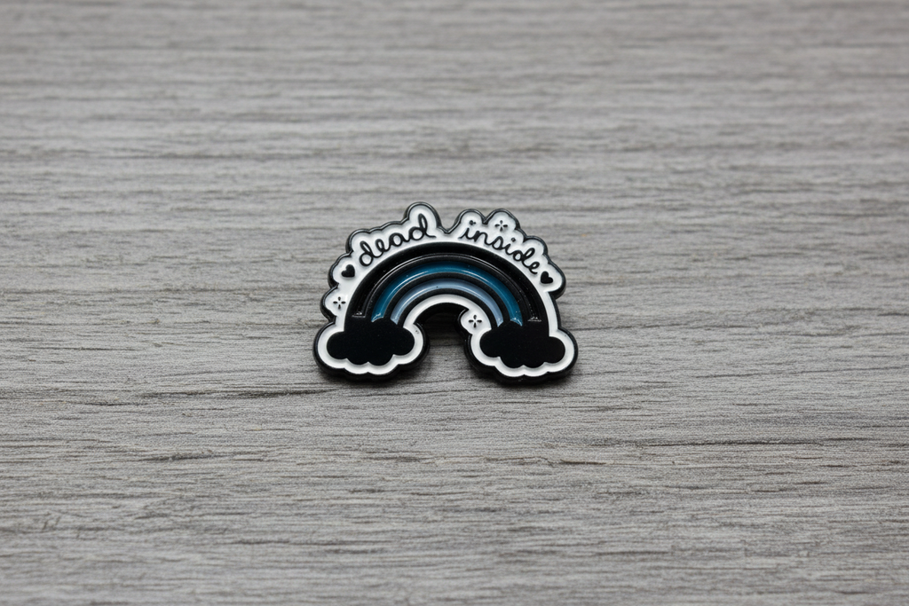 dead inside enamel pin on wood background alt style enamel pin with rainbow and cloud detail