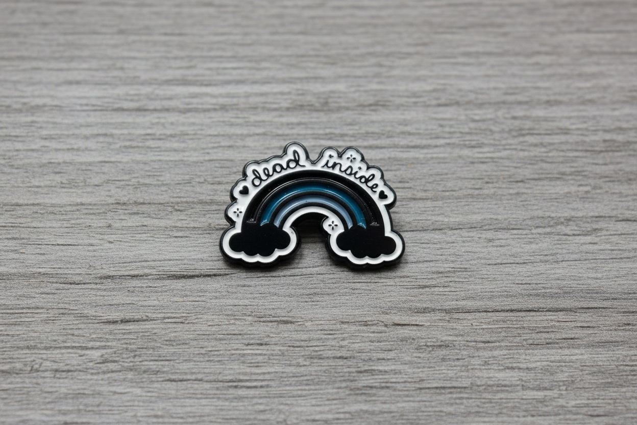 dead inside enamel pin on wood background alt style enamel pin with rainbow and cloud detail