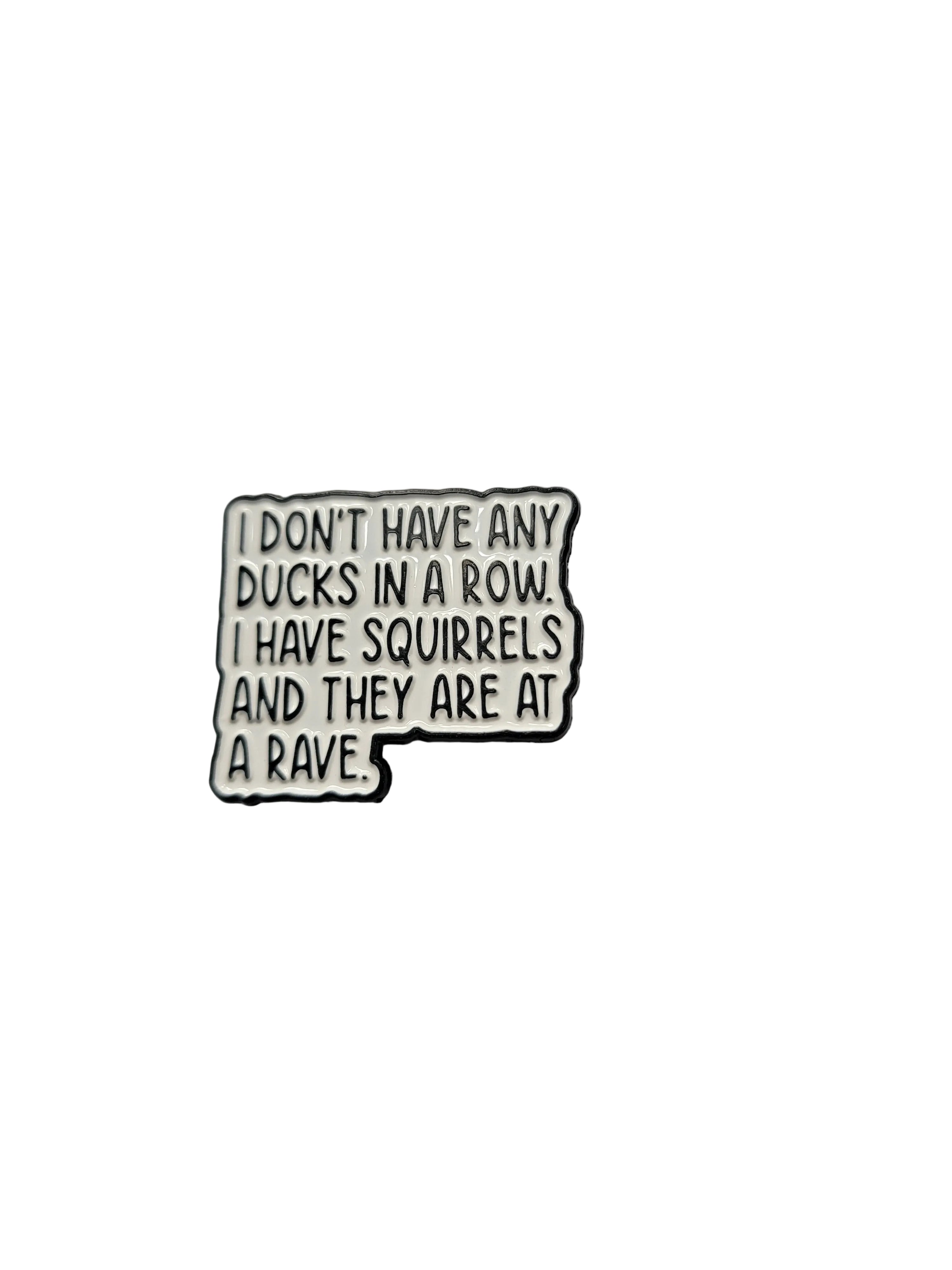 Enamel pin with humorous text on a plain background