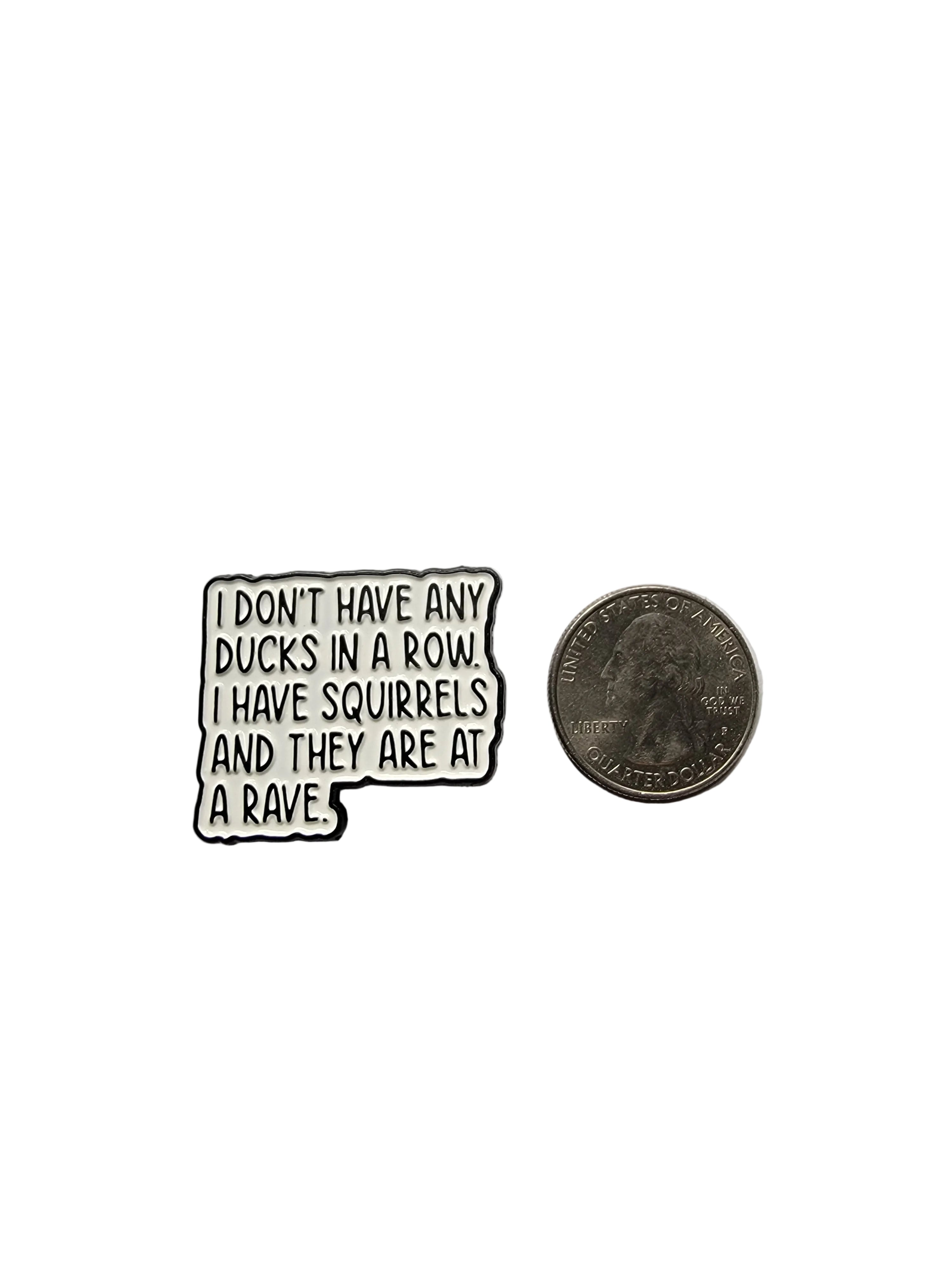 Small enamel pin with humorous text on a gray background