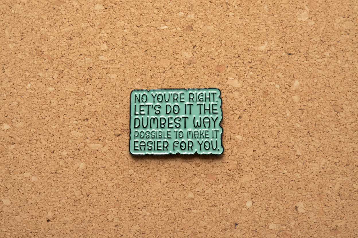 Green metal badge with text on a cork background