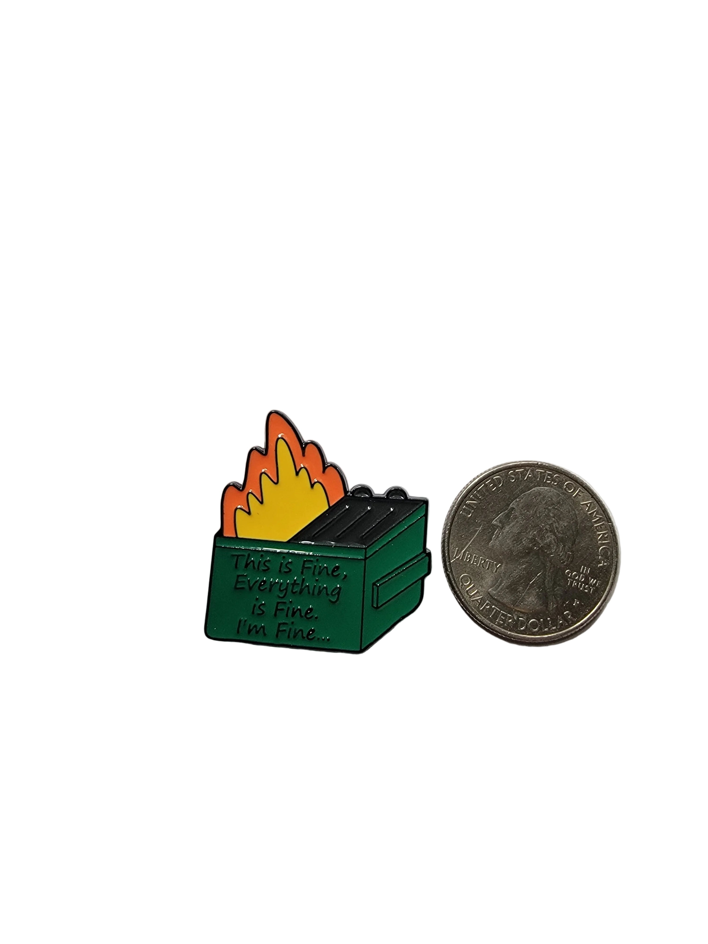 Small green and orange pin with a coin for scale on a gray background