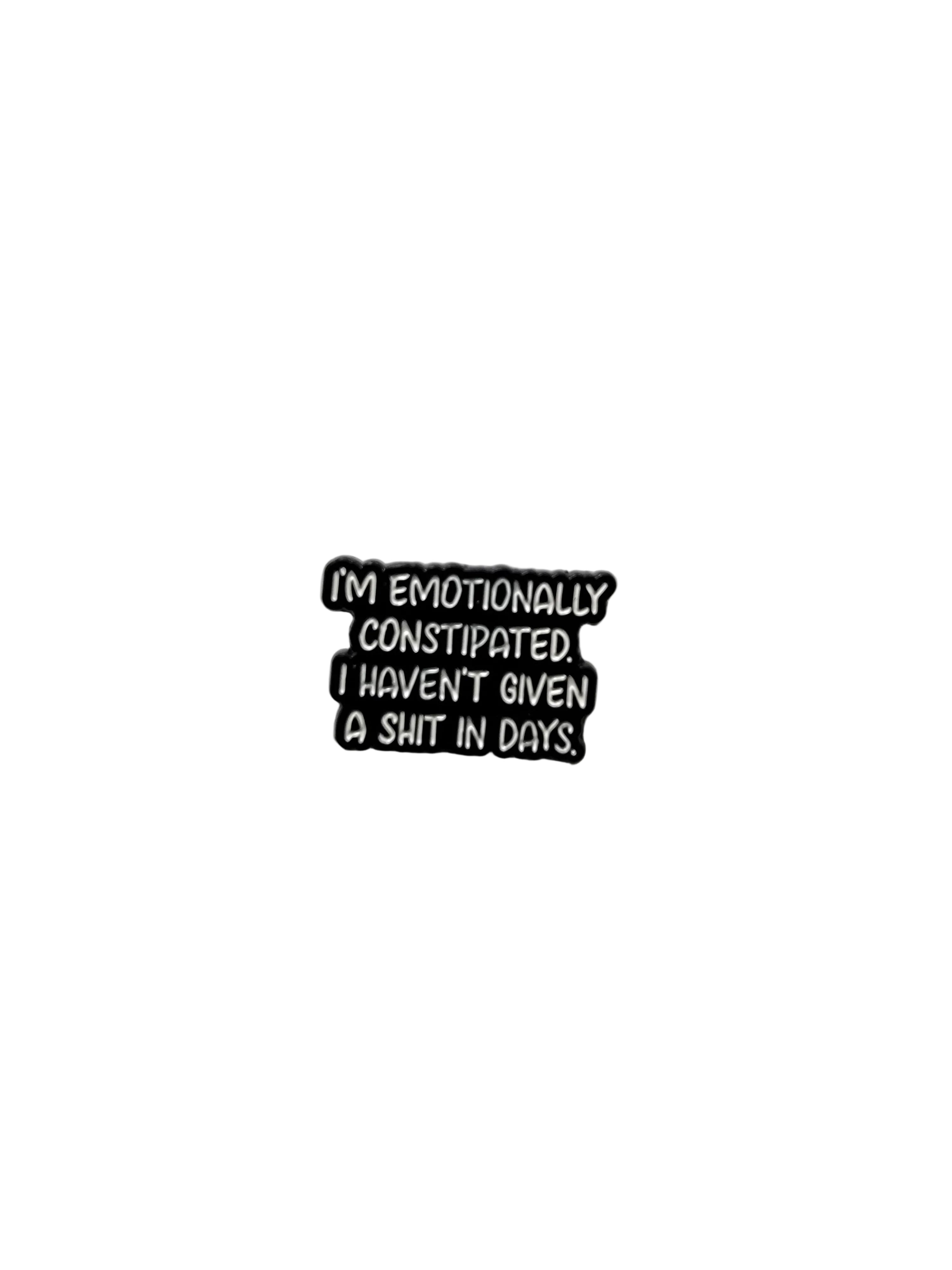 Black metal badge with text on a white background