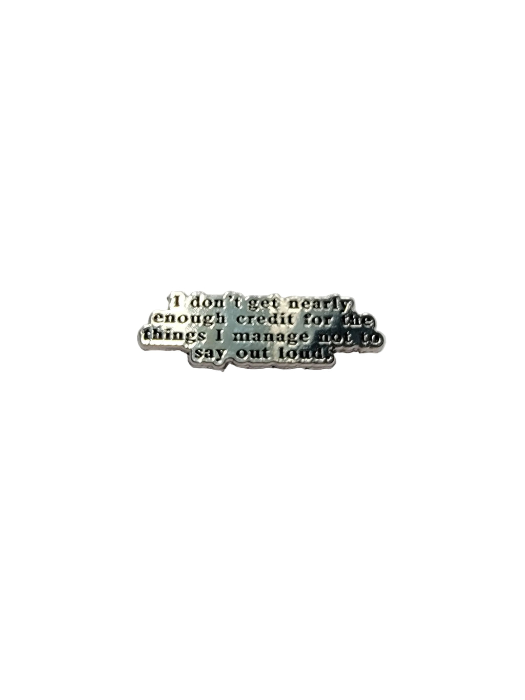 Small metal object with engraved text on a gray background