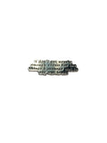 Small metal object with engraved text on a gray background
