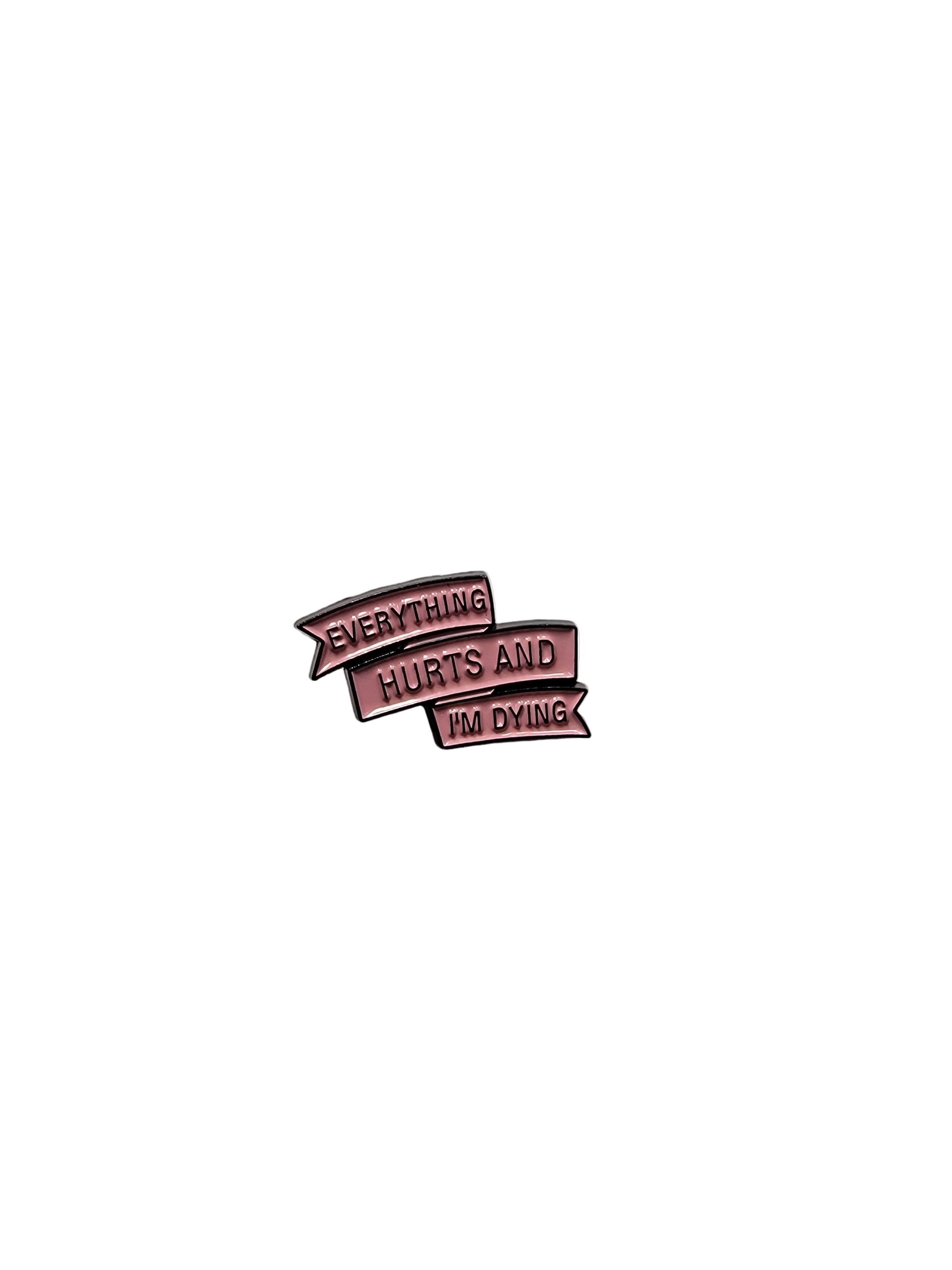 Metallic pink enamel pin with text on a gray background