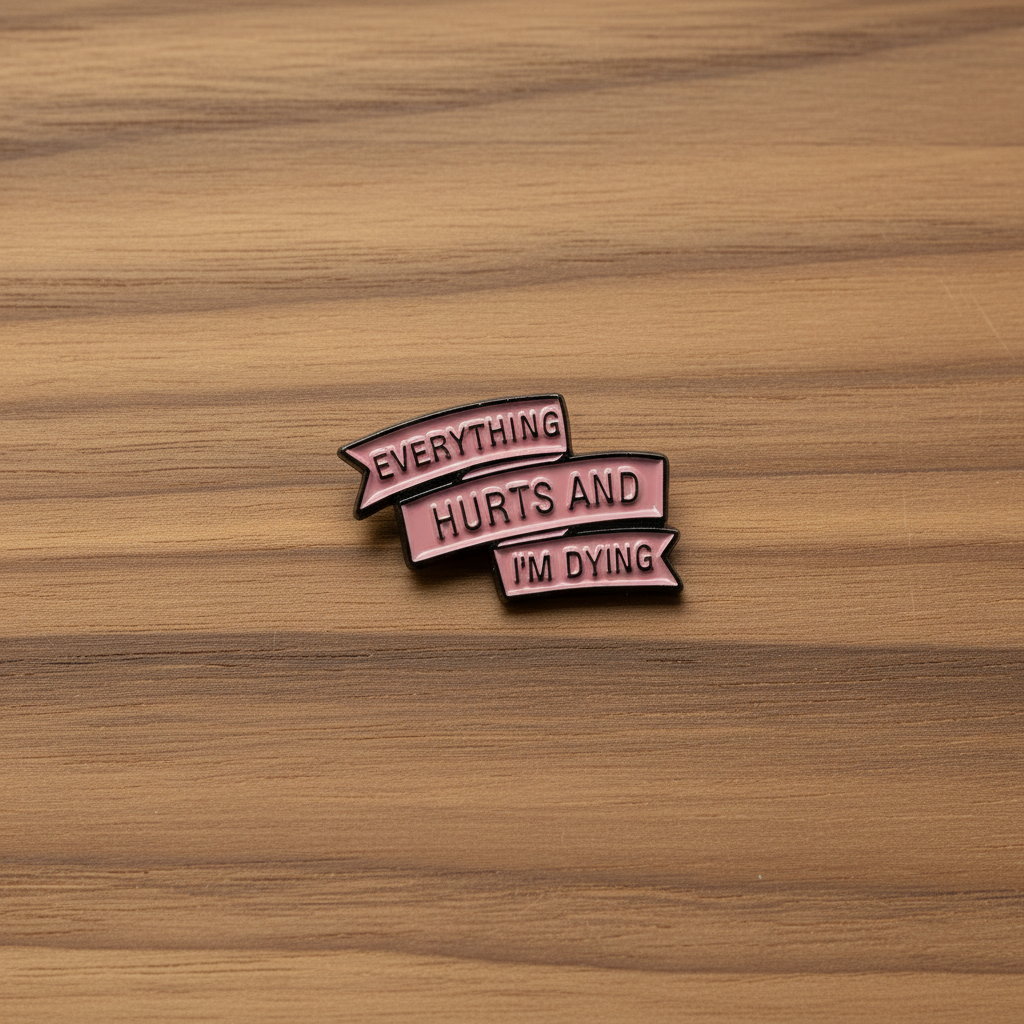 everyting hurts and I'm dying enamel pin on wood backgroundfunny meme enamel pin with ribbon detail