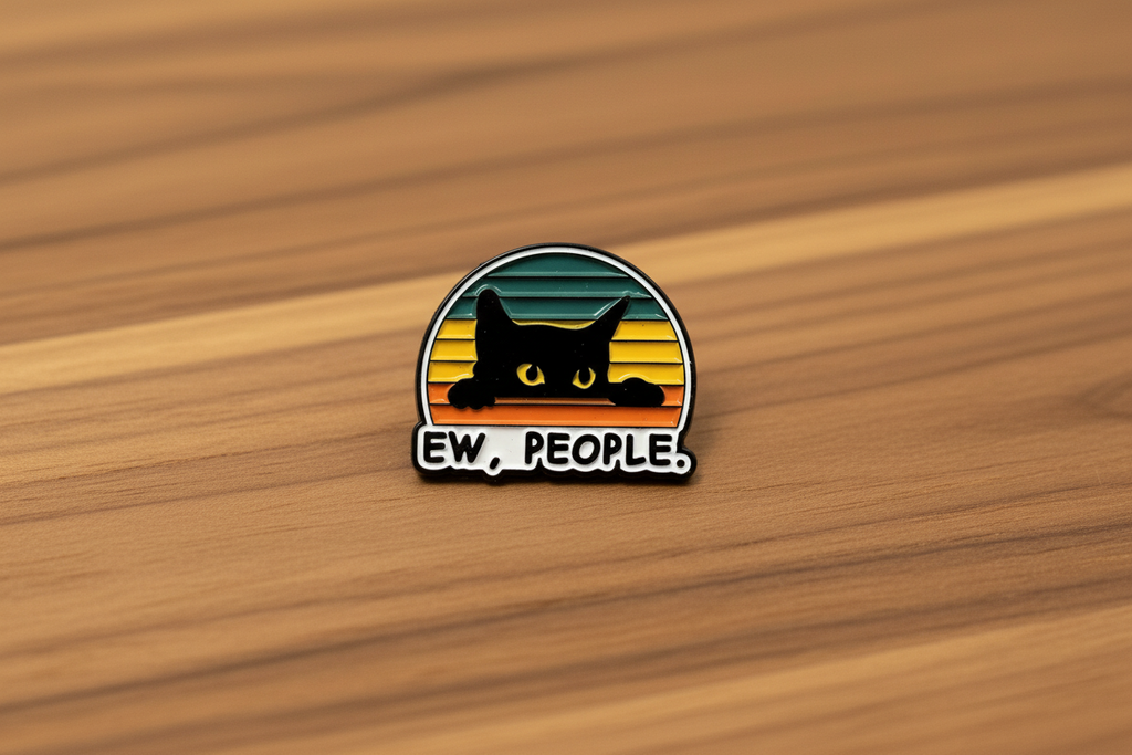 Pin with a black cat design and 'EW. PEOPLE.' text on a wood background