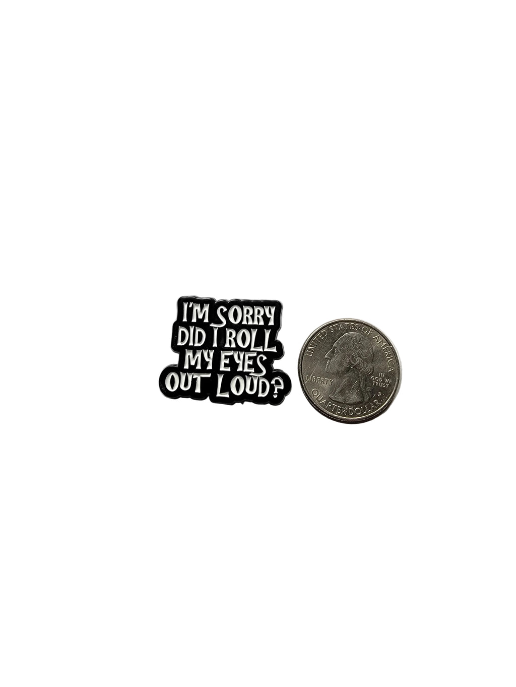 Small black and white enamel pin with text on a gray background