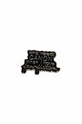 a black enamel pin with gold text on a white background