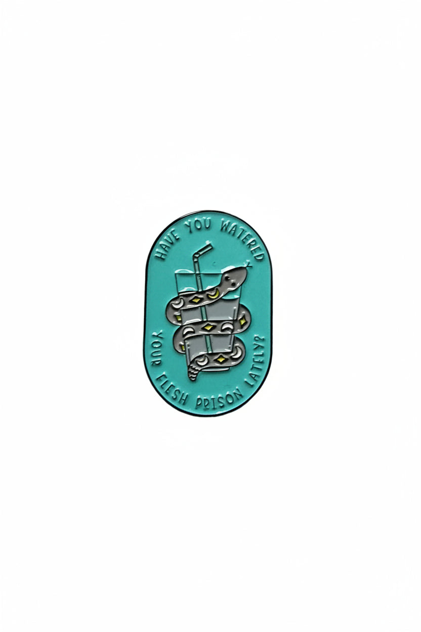 a teal pin with a snake and water on a white background