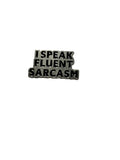 Metallic badge with 'I speak fluent sarcasm' text on a white background