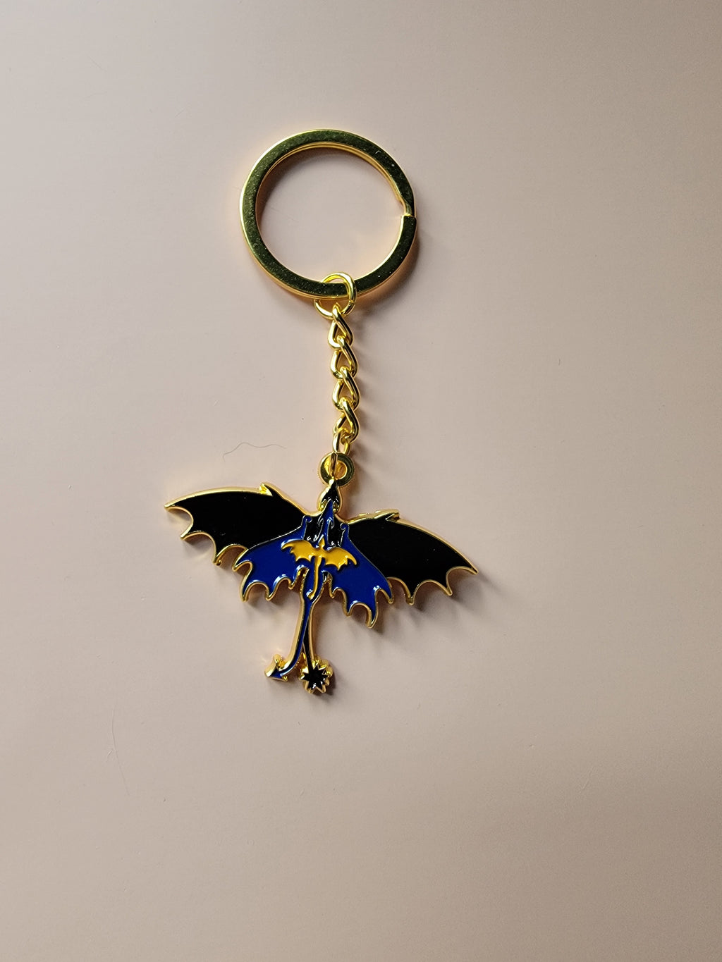 Keychain with a dragon design on a beige background