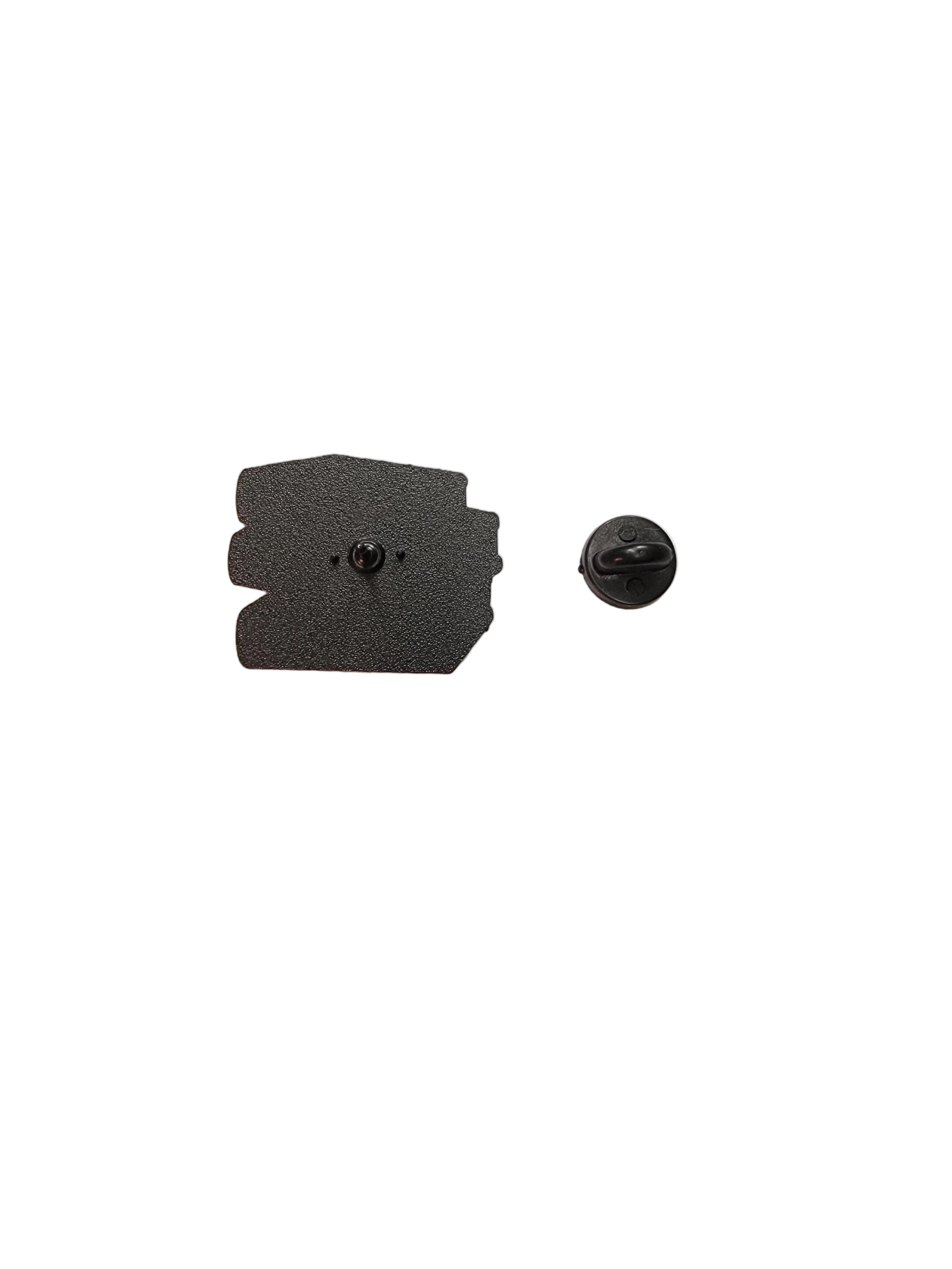 Black pin back on a white surface 