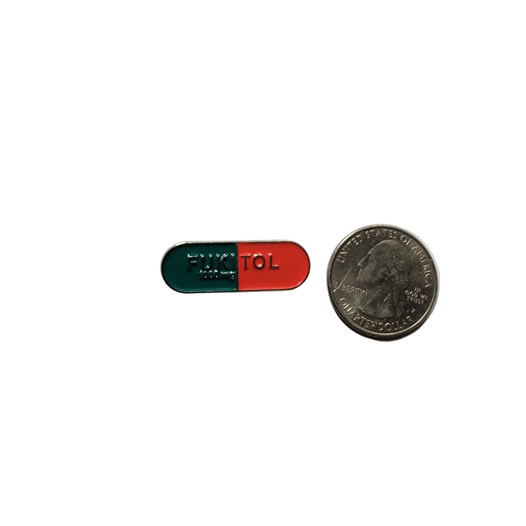 Fukitol enamel pin shown next to quarter for size reference gen z enamel pin dims 1 1/8 in W x 1/2 in H