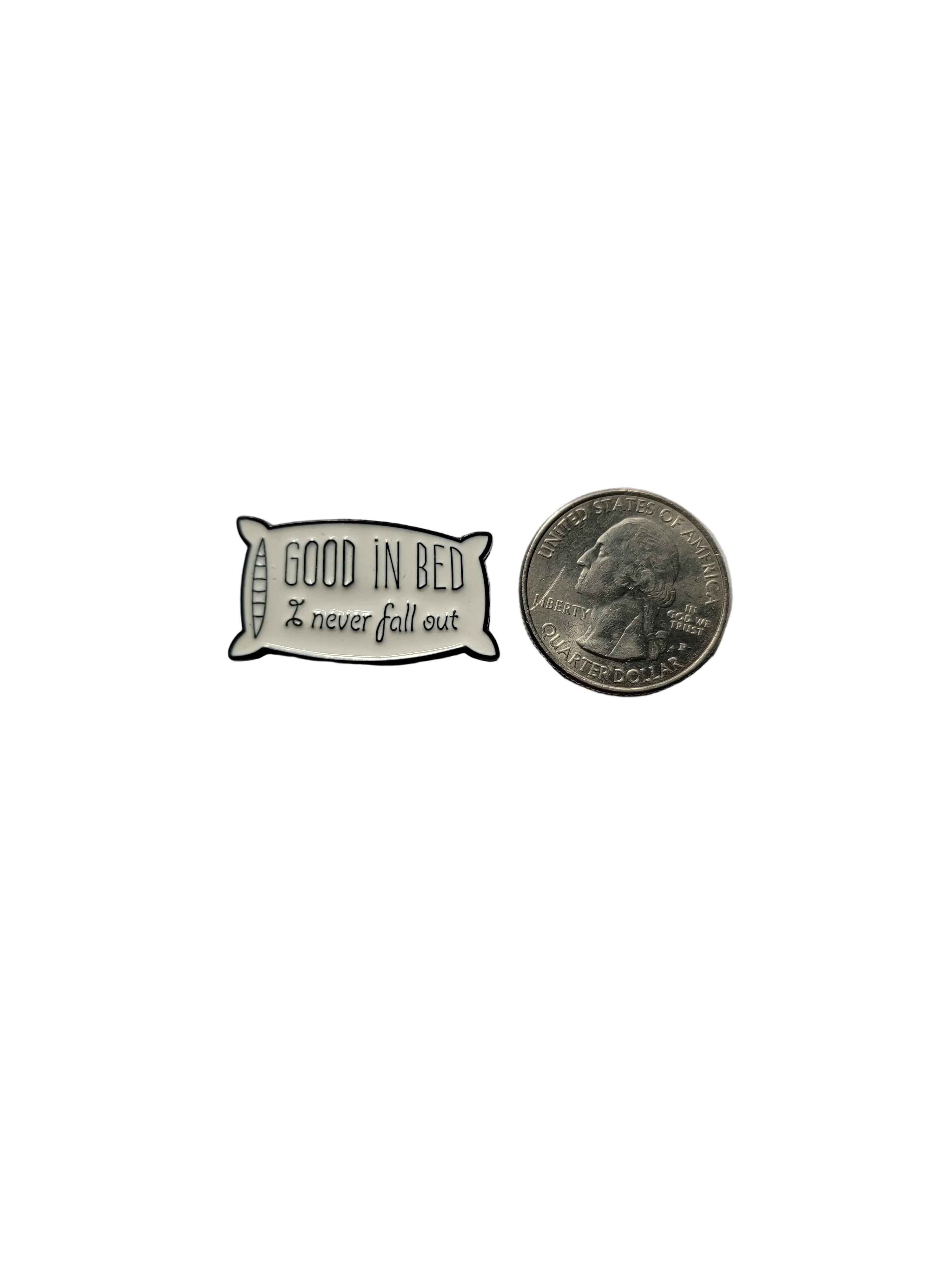 Small pillow-shaped enamel pin with 'Good in bed, never full out' text next to a quarter on a light gray background