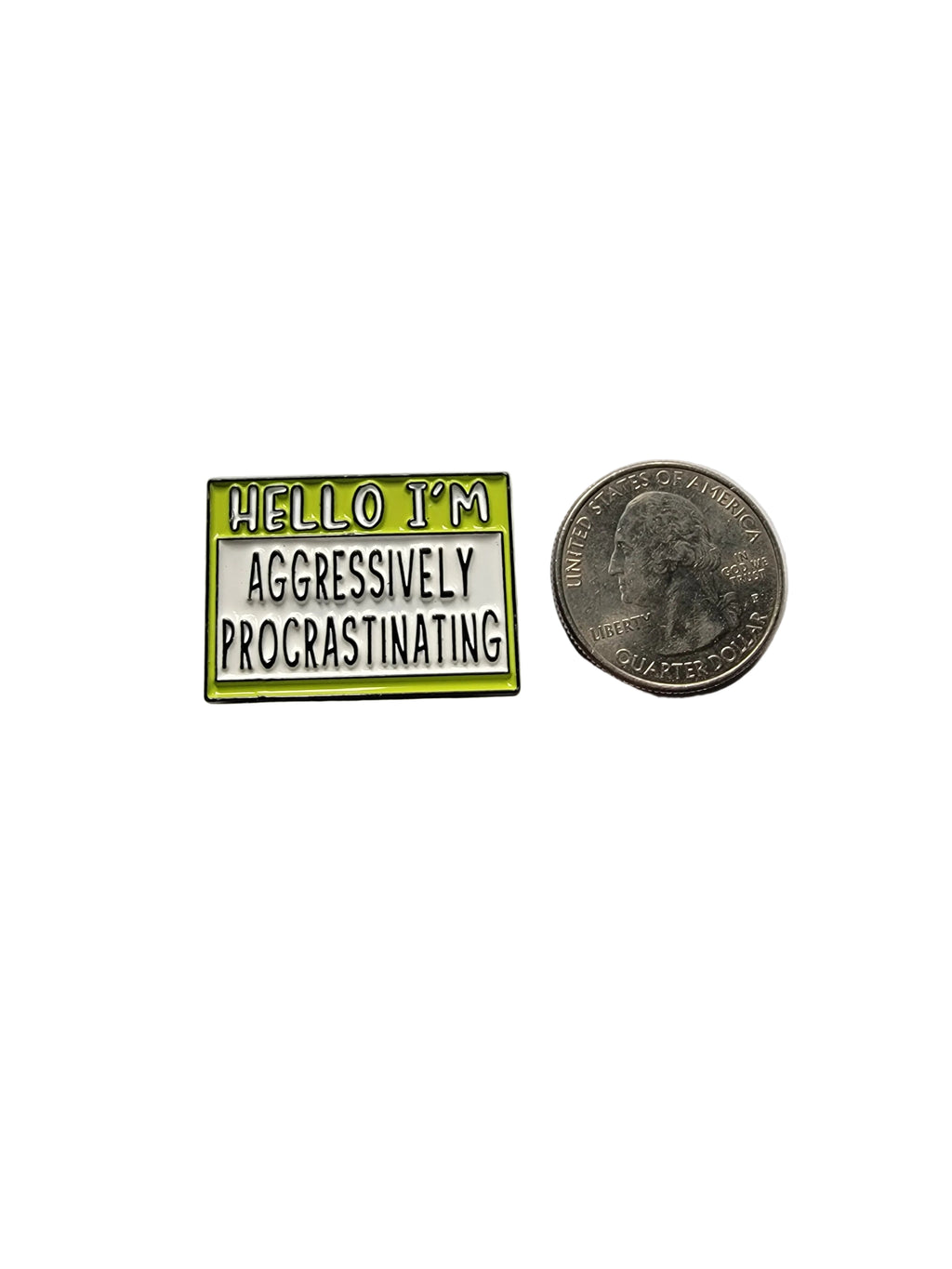 Small enamel pin with text next to a quarter on a gray background