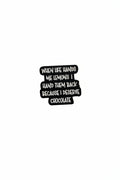 a black pin with white text with a funny quote on a white background