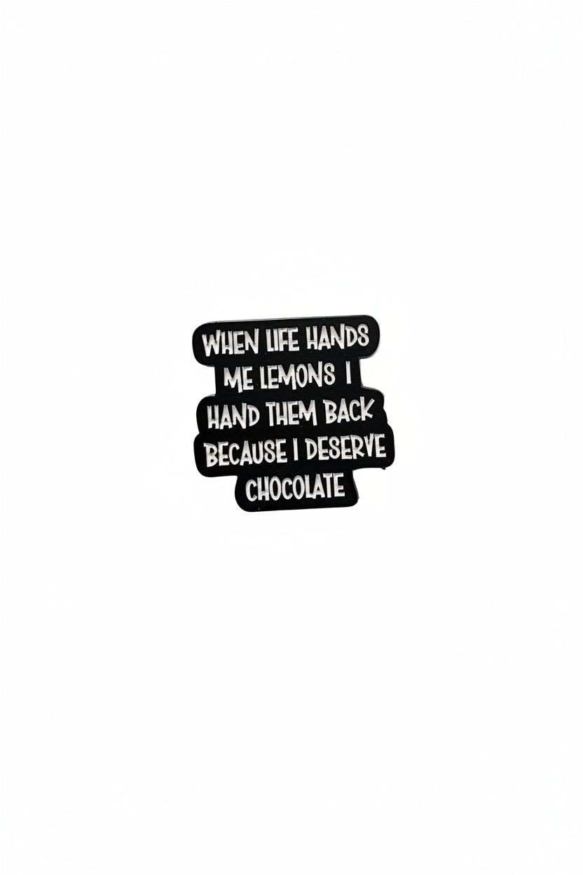 a black pin with white text with a funny quote on a white background