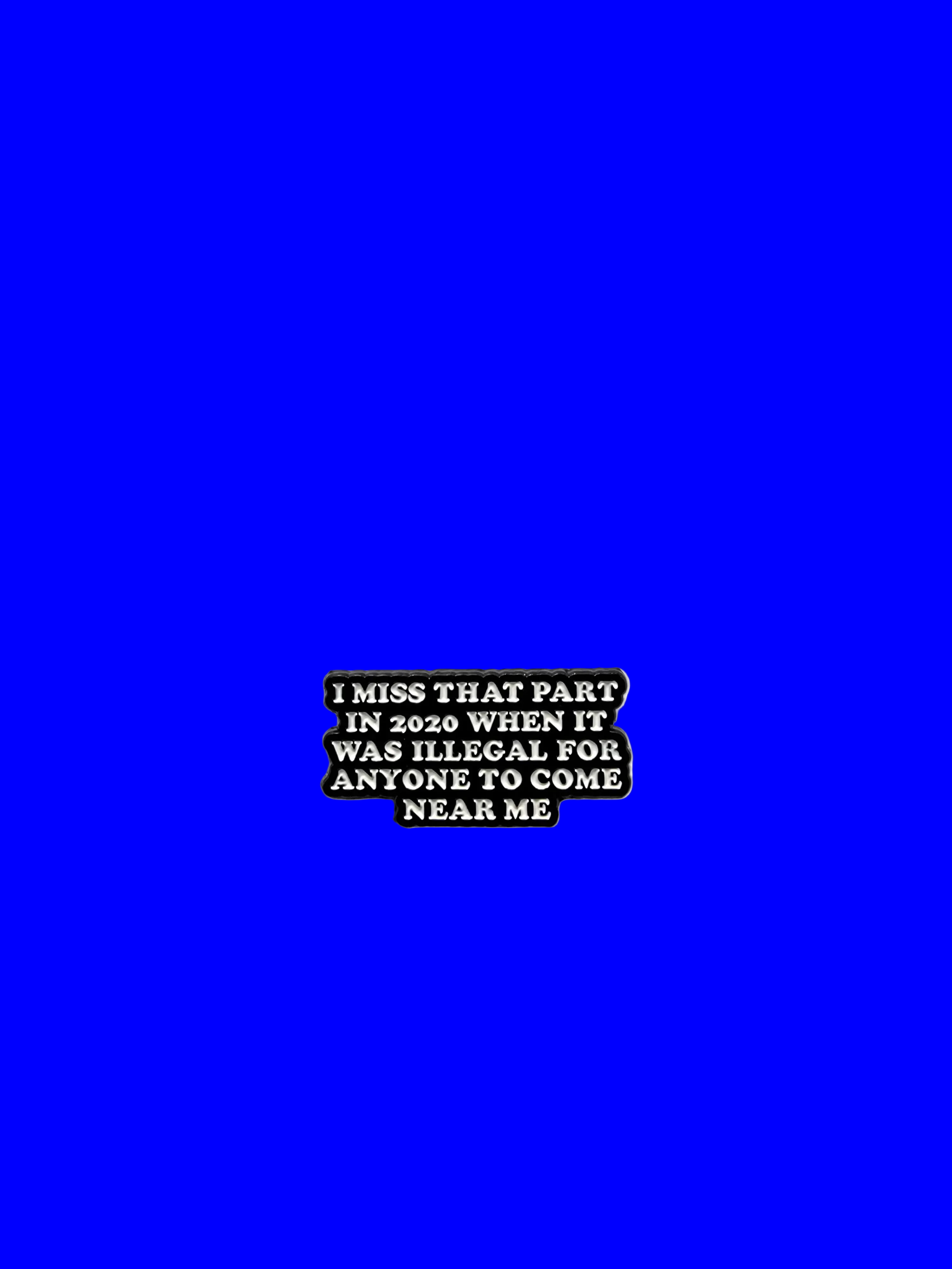 Black rectangular pin with white text on a blue background