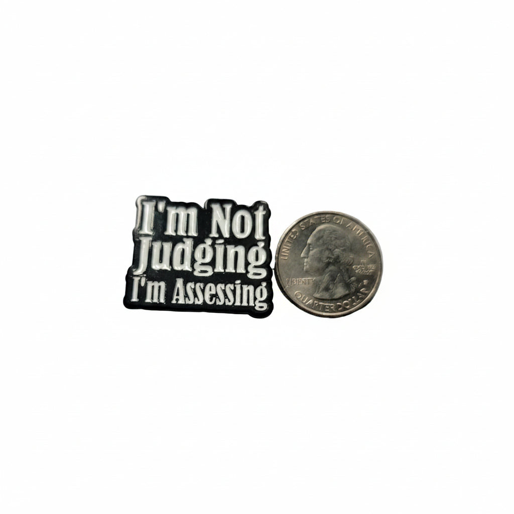 I'm not judging i'm assessing enamel pin shown next to quarter for size reference gen z enamel pin dims Hard enamel pin
Design: Black with white text
Dims: 1 in W x 1 1/8 in H