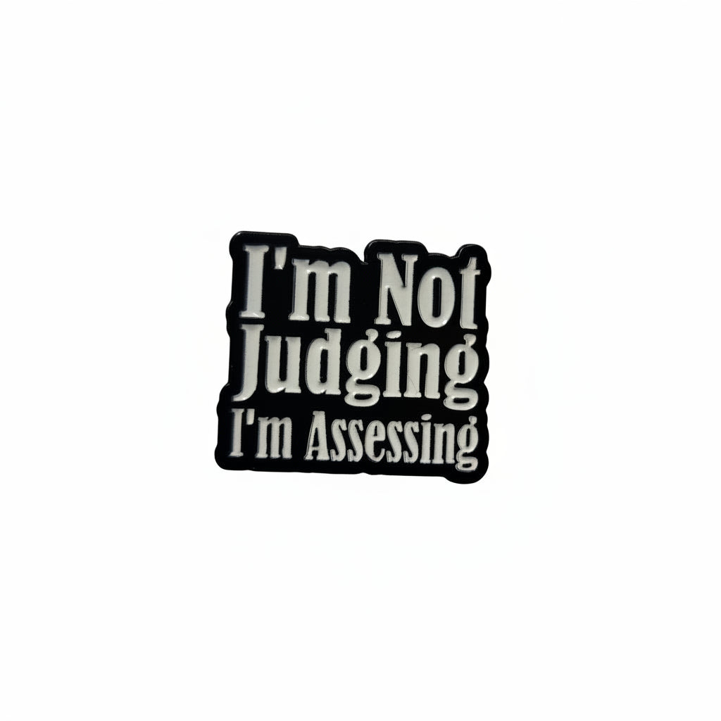 I'm not judging i'm assessing enamel pin featuring black and white text design, sarcastic gift for jackets and bags
