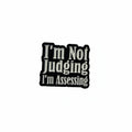 I'm not judging i'm assessing enamel pin featuring black and white text design, sarcastic gift for jackets and bags
