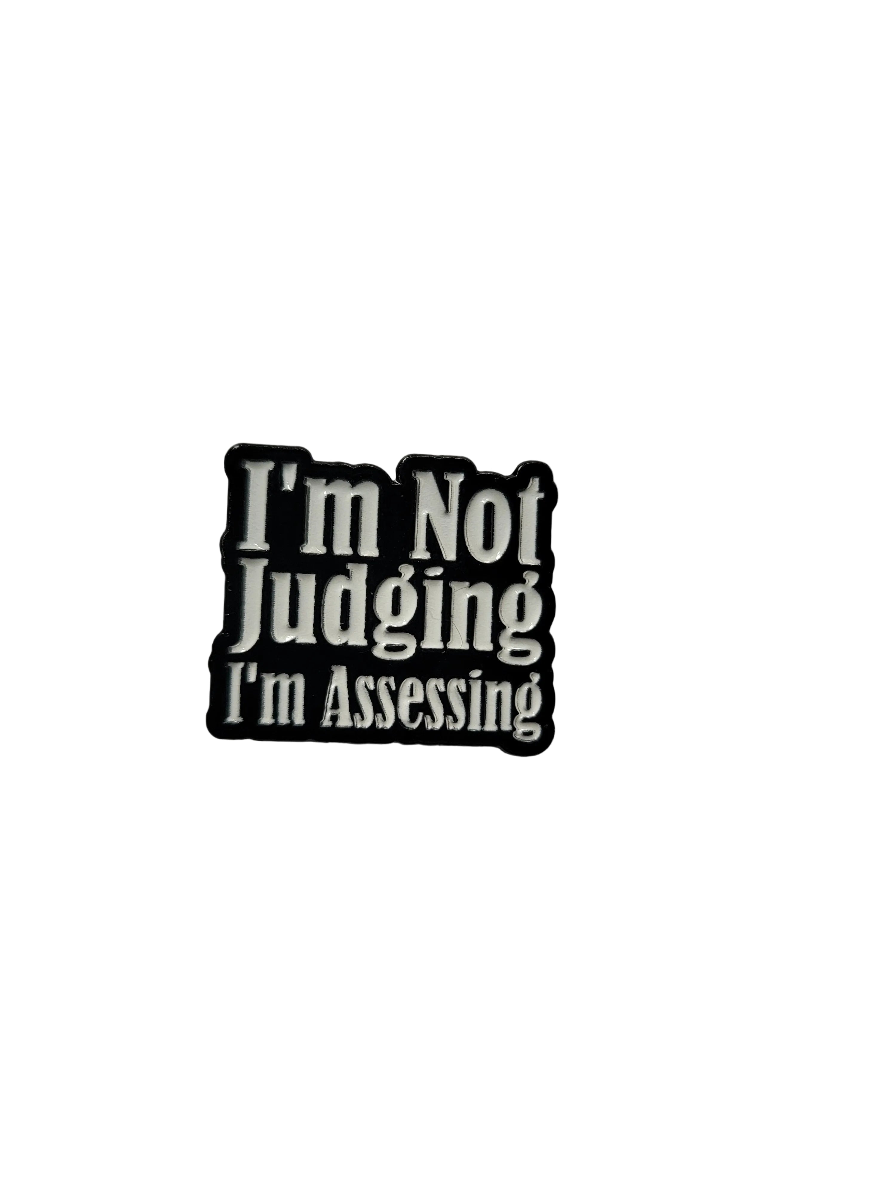 a black enamel pin with white text on a white background

