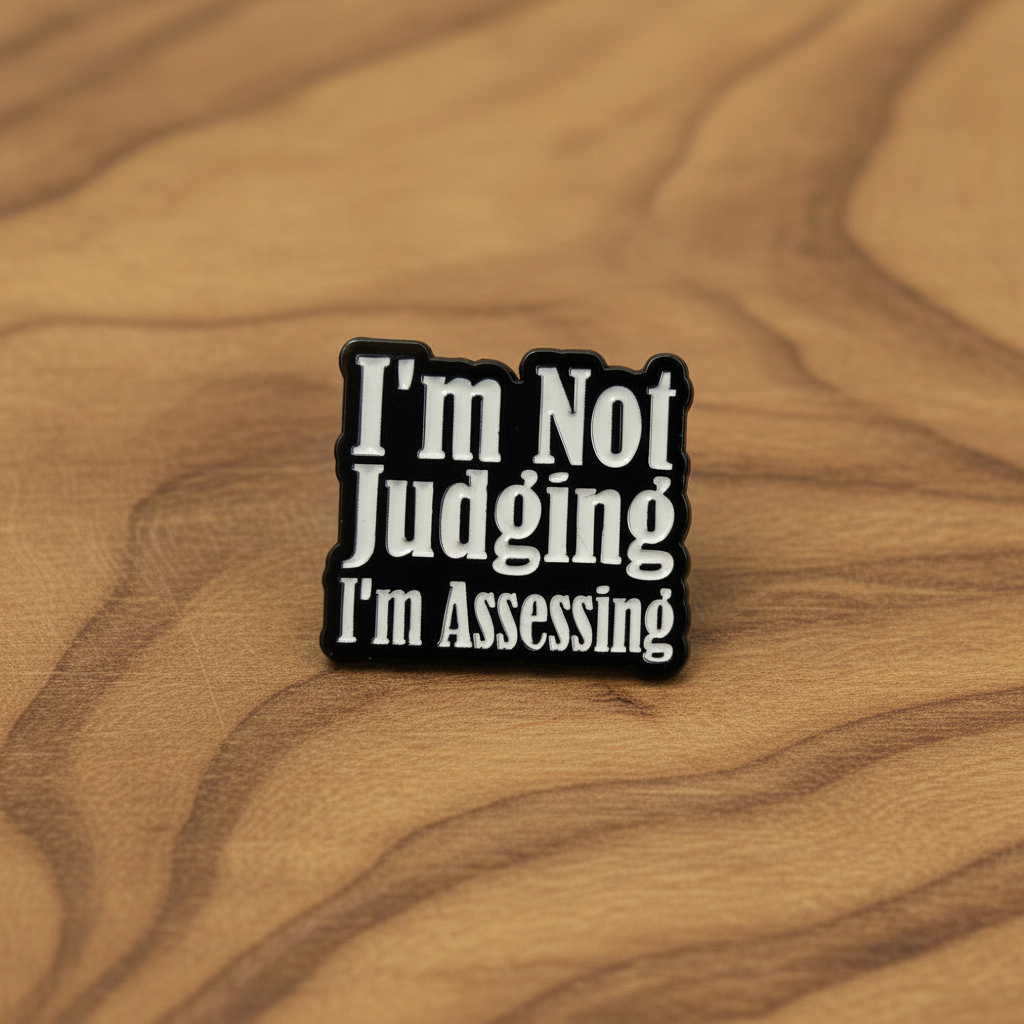 I'm not judging i'm assessing enamel pin on wood background funny enamel pin with black and white text detail