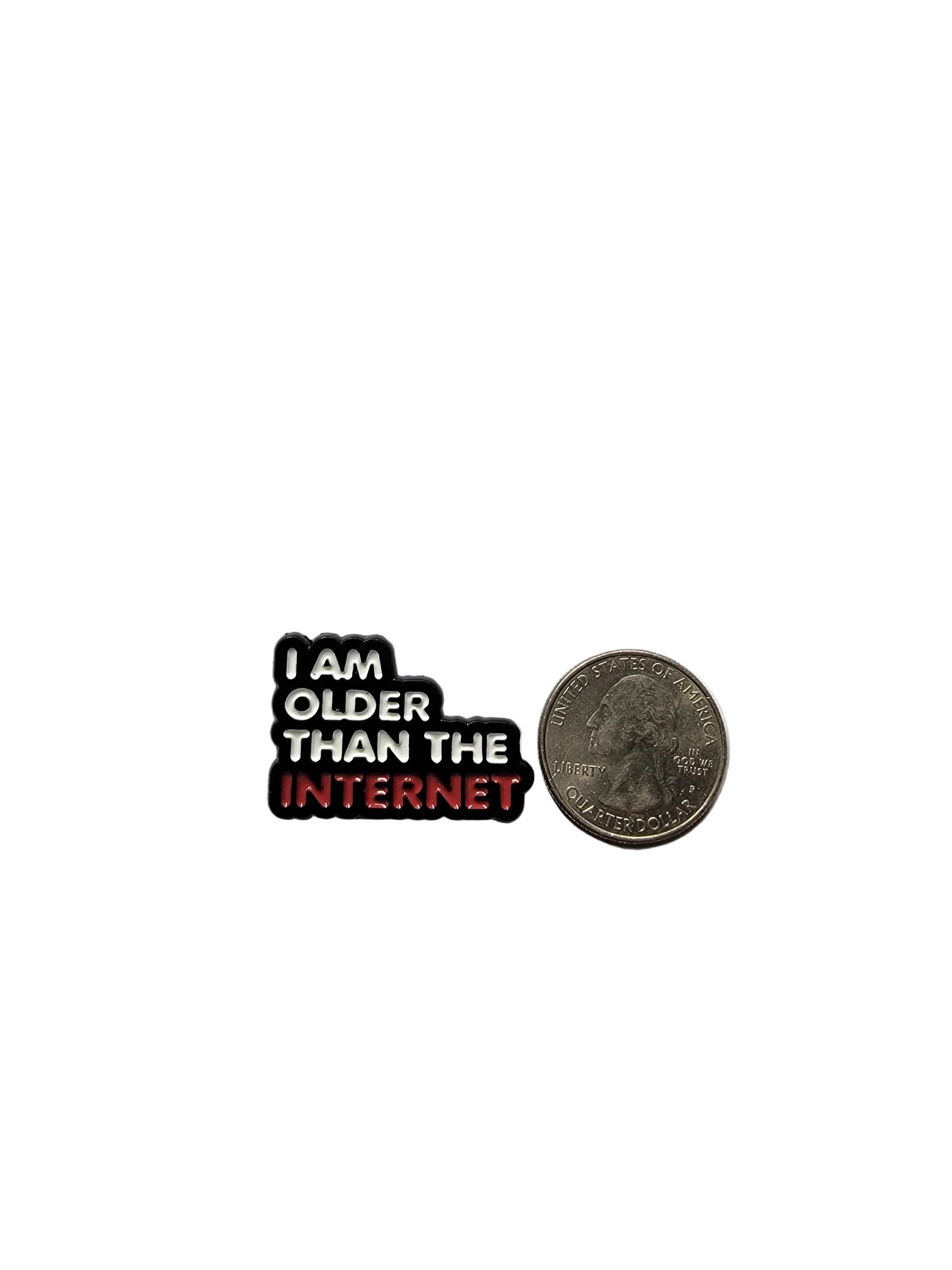 Small enamel pin with 'I am older than the internet' text next to a quarter on a gray background