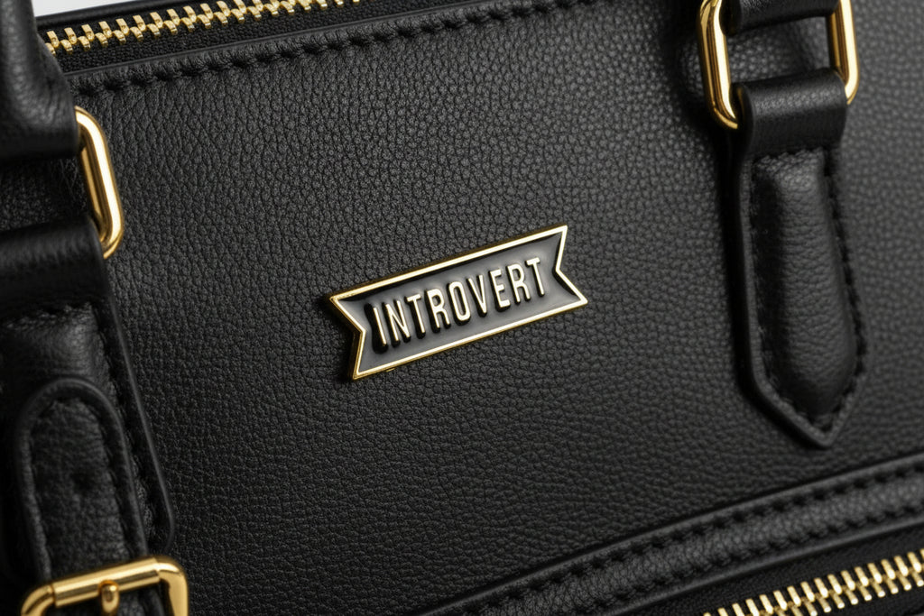 Pin with 'Introvert' text on black bookbag