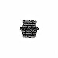 Black metal badge with text on a gray background
