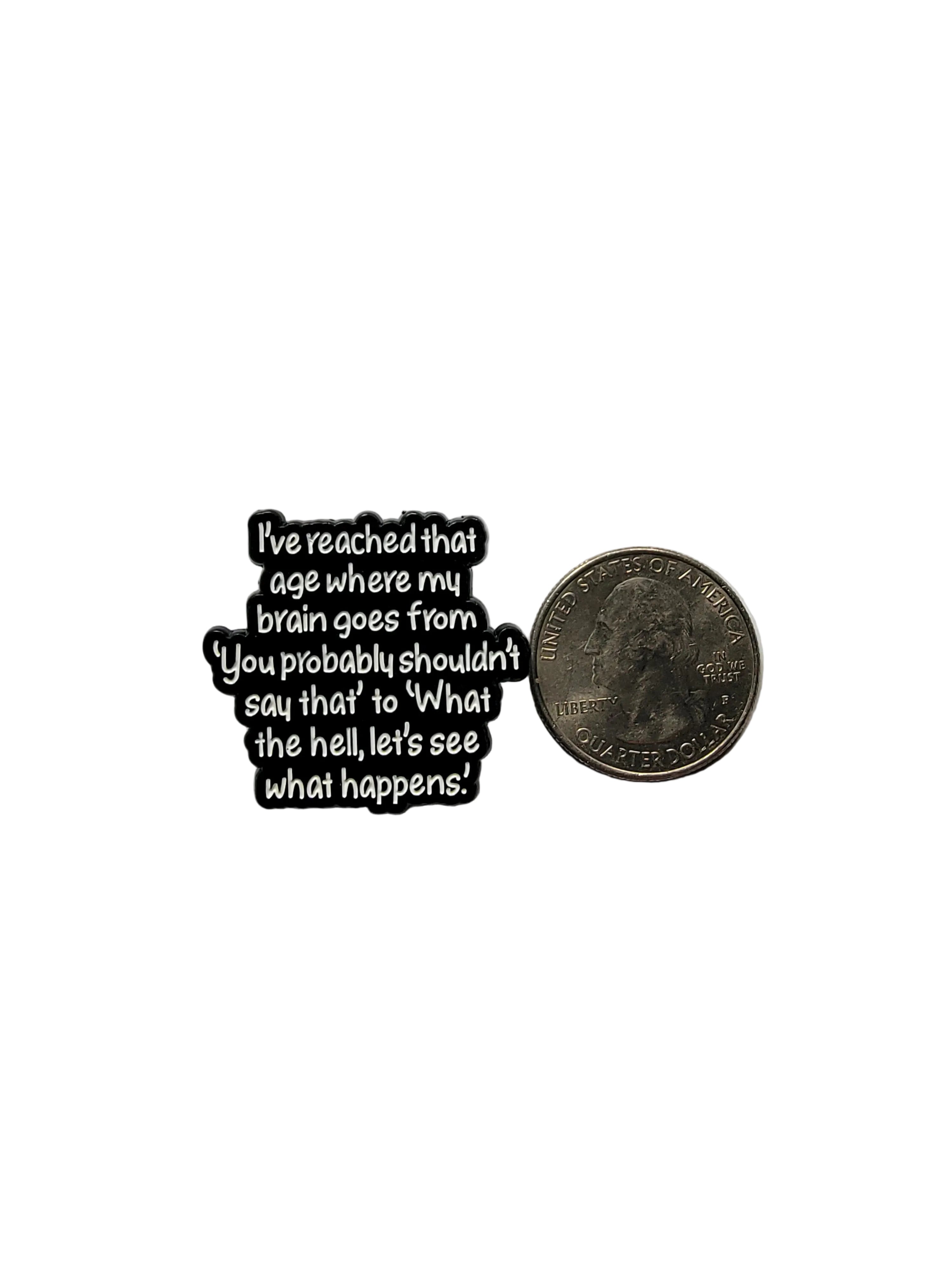 Black metal badge with text on a white background
