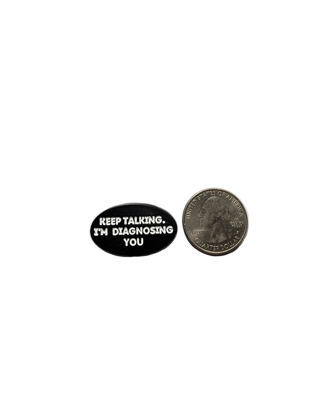 Small black and white pin with text on a gray background