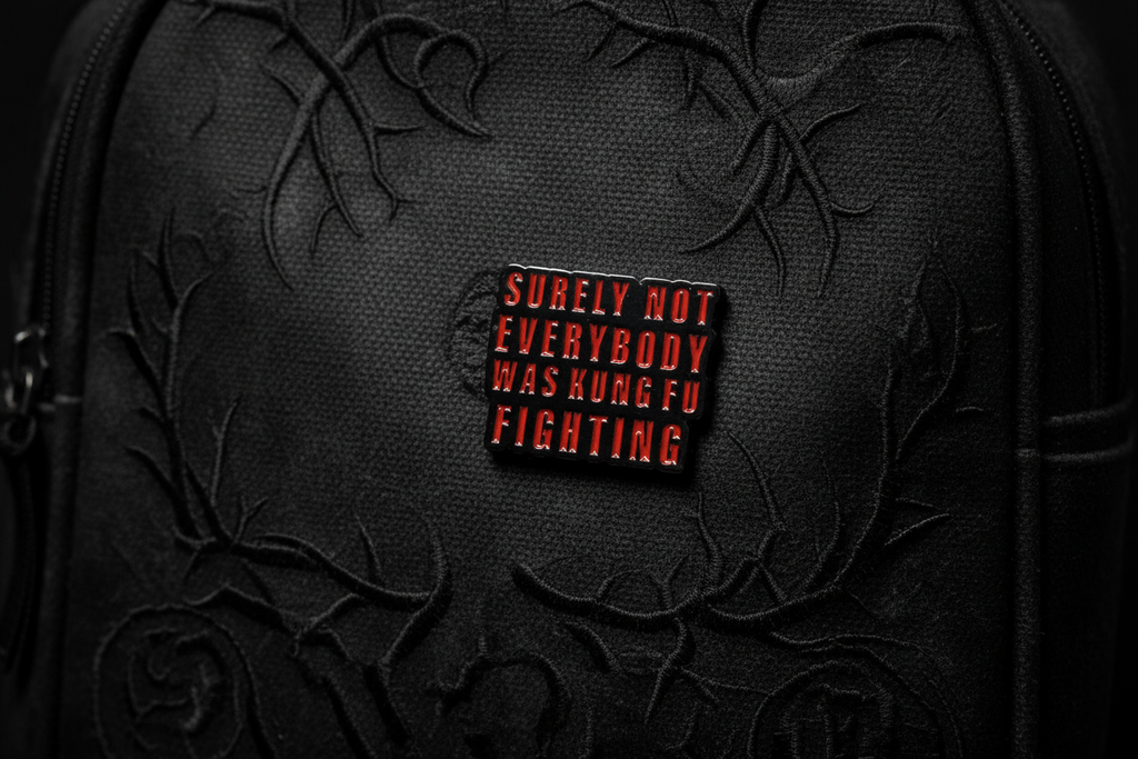Small rectangular object with text on a black bookbag background