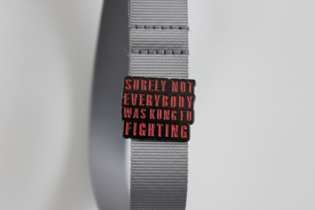 Small rectangular object with text on a white lanyard background