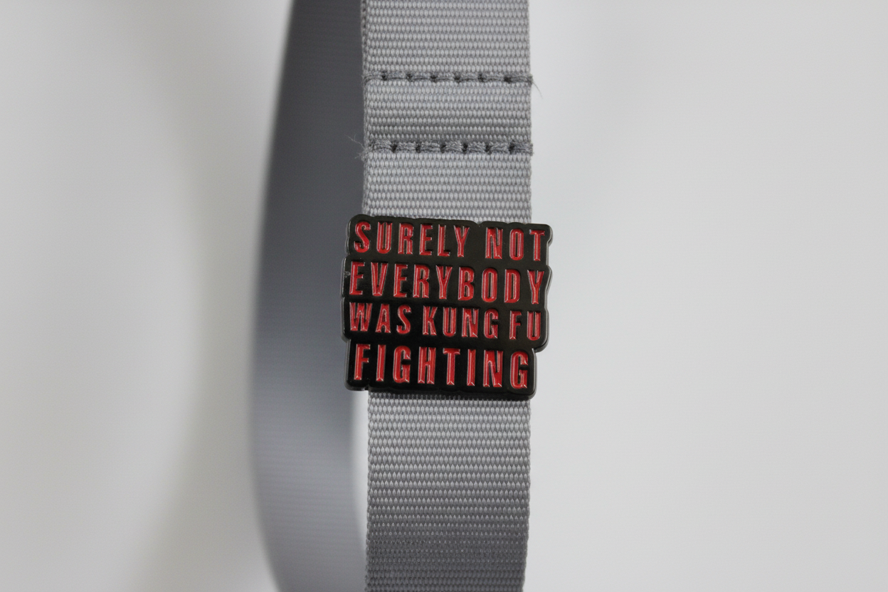 Small rectangular object with text on a white lanyard background