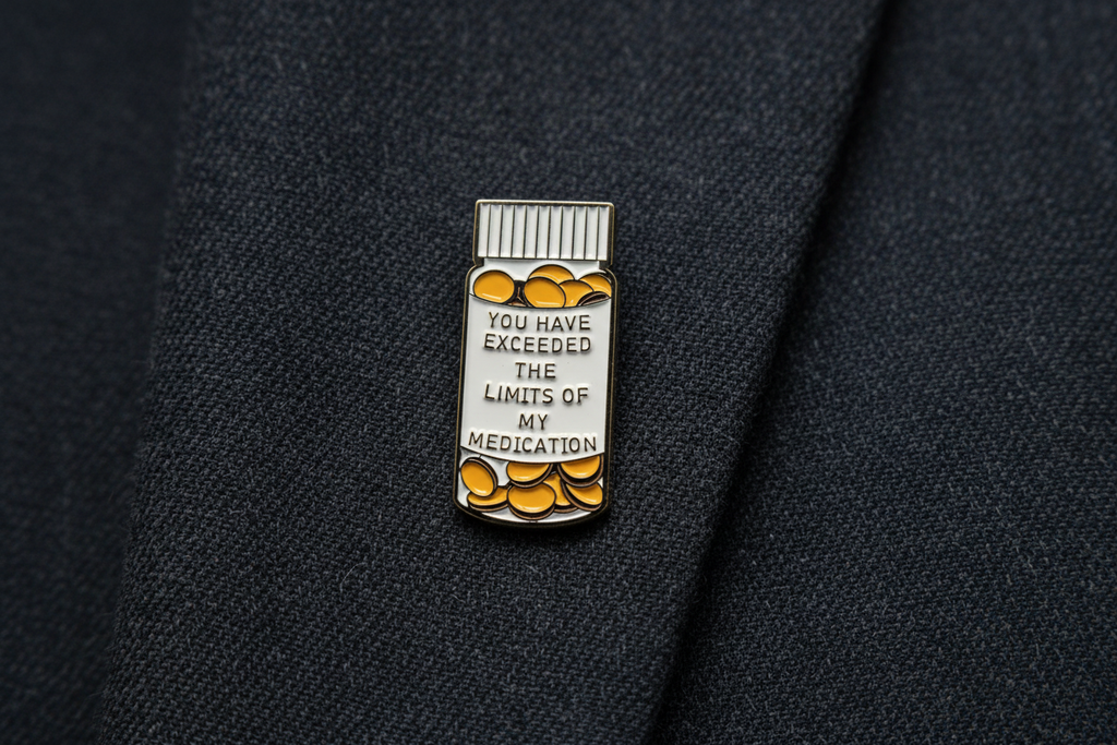 medicine bottle pin with text on a fabric background