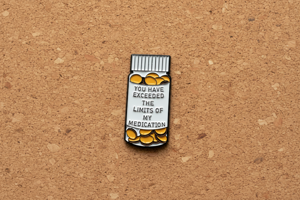 medicine bottle pin with text on a cork background