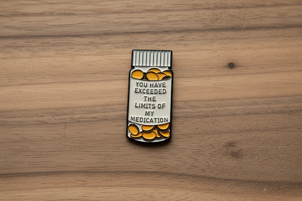 medicine bottle pin with text on a wood background