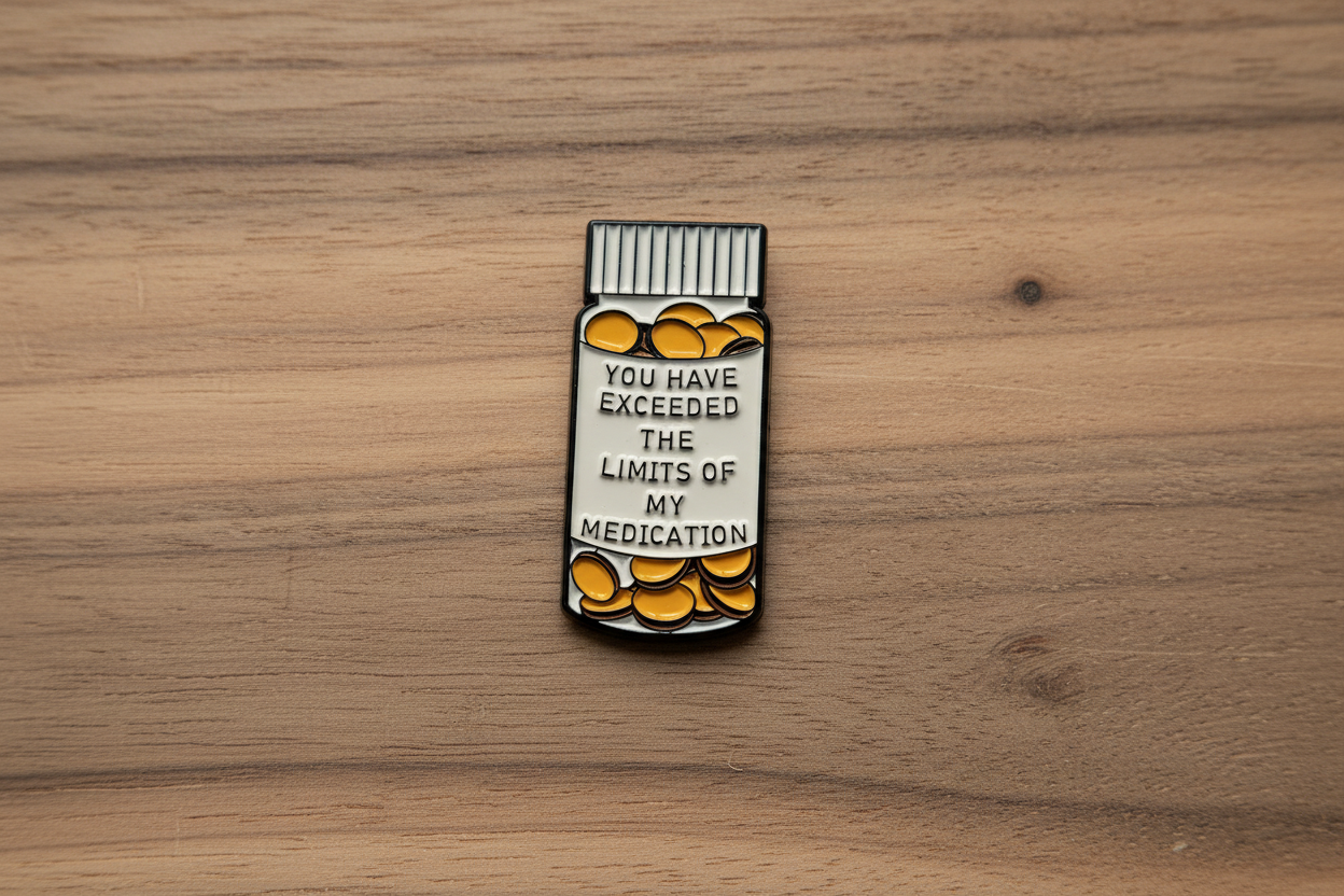 medicine bottle pin with text on a wood background