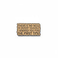 a beige enamel pin with black text on a white background