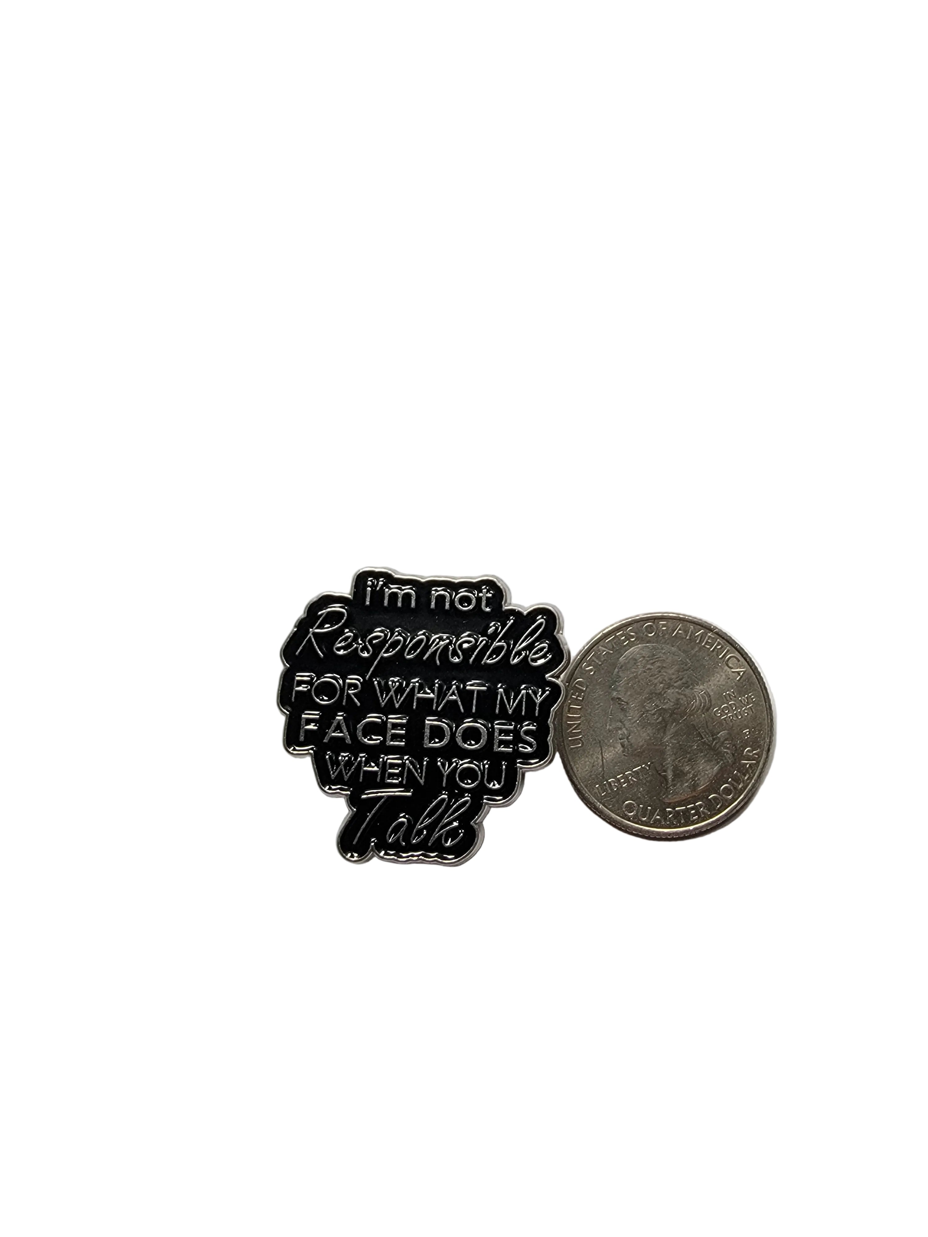 Black and white enamel pin with text on a gray background