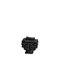 Black enamel pin with text on a white background