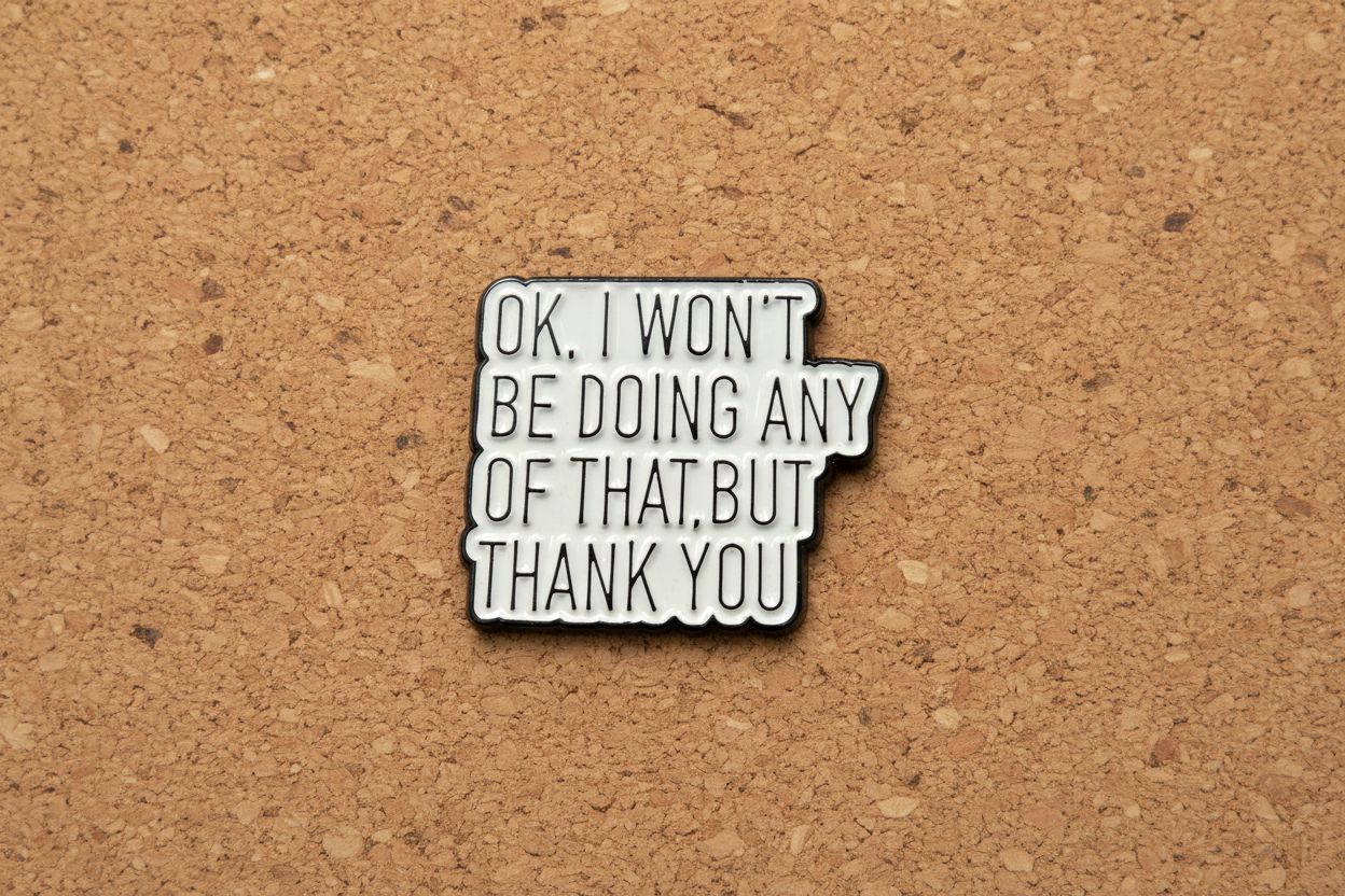Metallic pin with text on a cork background