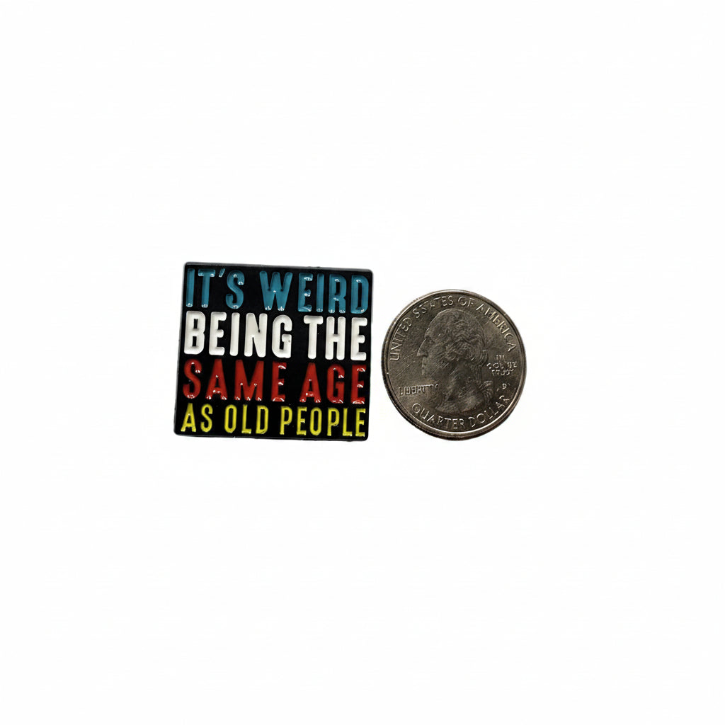 It's weird being the same age as old people enamel pin shown next to quarter for size reference boomer enamel pin dims 1 1/4 in W x 1 in H