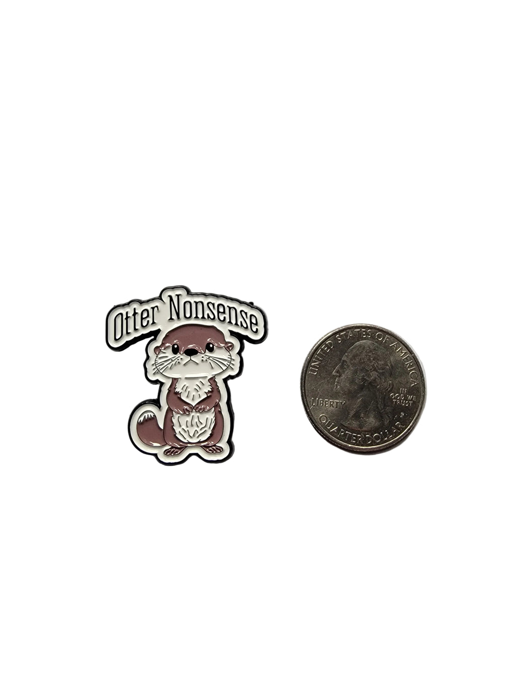 Small enamel pin of a otter with text on a gray background, next to a quarter for scale.