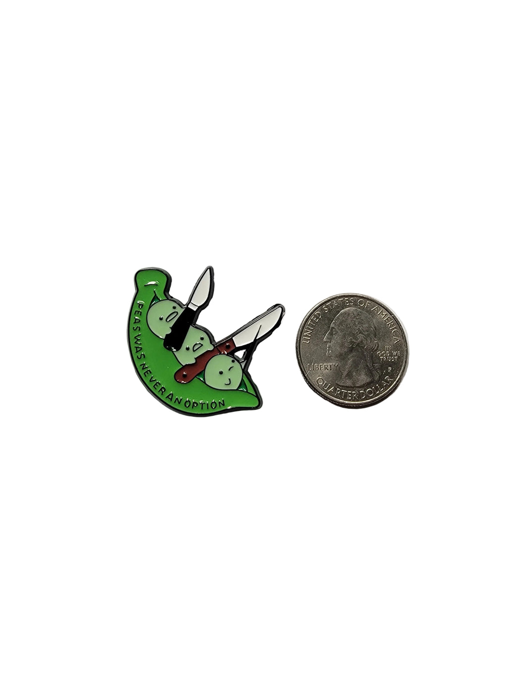 a green pea pod pin with text next to a quarter for scale on a white background