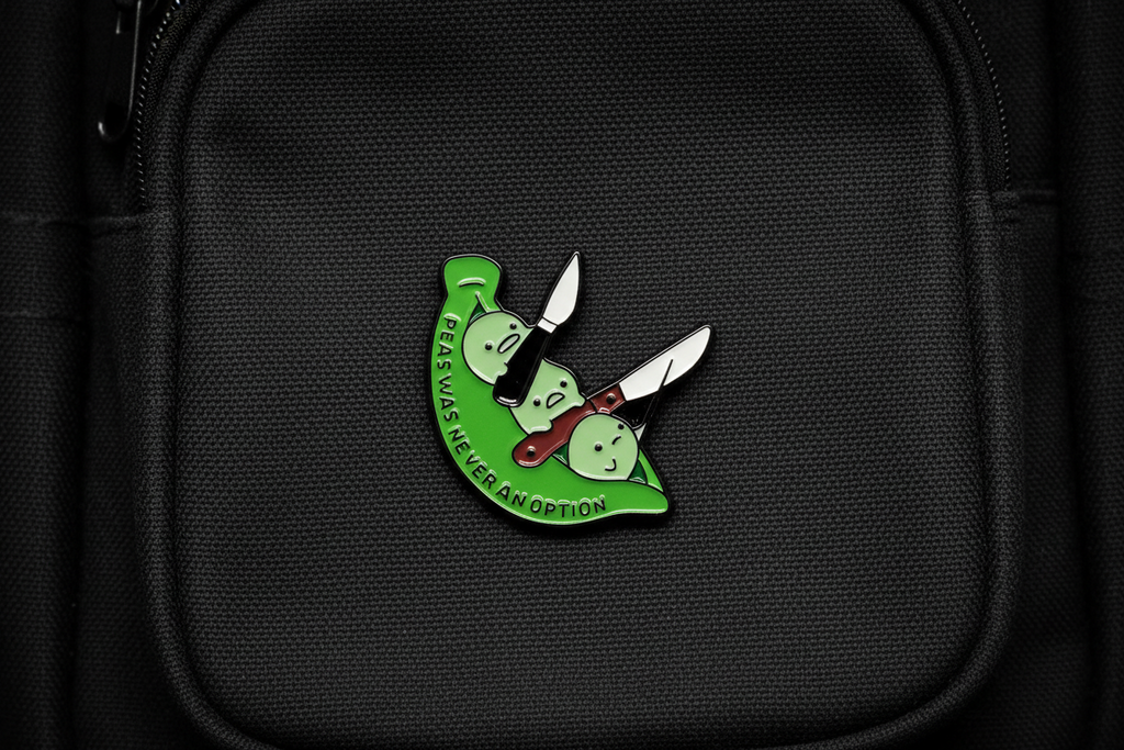 Green and white pin with text on a black bookbag background